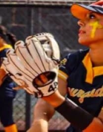 A baseball player holding up his glove with the number 1 2.