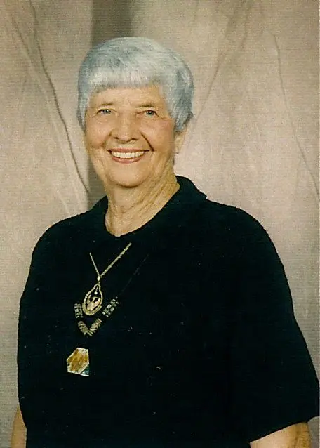 A woman with white hair and wearing a black shirt.