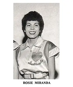 A woman in a uniform is smiling for the camera.