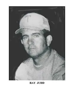 A black and white photo of a man wearing a baseball cap.