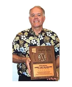 A man holding a plaque in front of him.