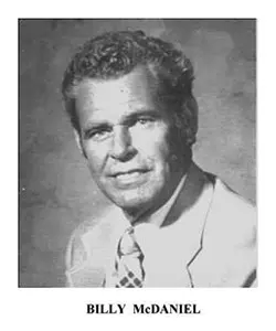 A black and white photo of a man in a suit.