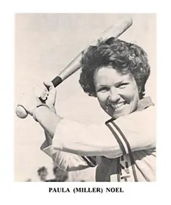 A woman holding a baseball bat in her hands.