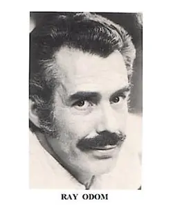 A black and white photo of a man with mustache.