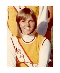 A woman in yellow and white uniform sitting on top of a chair.