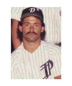 A baseball player in pinstriped uniform with a mustache.