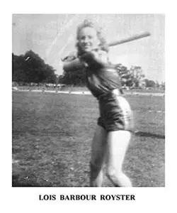 A woman is swinging a baseball bat on the field.