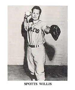 A baseball player is holding his glove up.