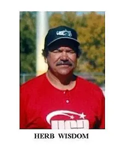 A man in red shirt and black hat.