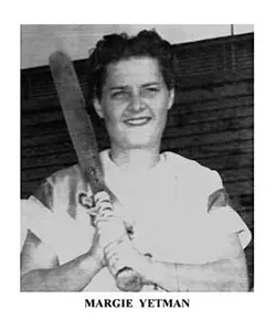 A black and white photo of a woman holding a baseball bat.