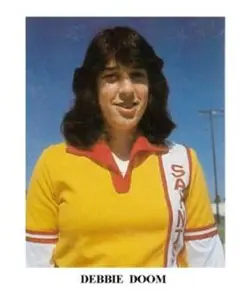 A woman in yellow shirt and white hair.