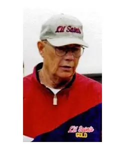 A man in red and white jacket wearing glasses.