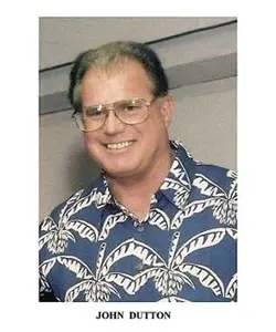 A man with glasses and a hawaiian shirt.