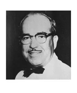 A black and white photo of an older man wearing glasses.