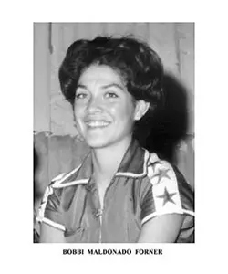 A black and white photo of a woman with stars on her shirt.