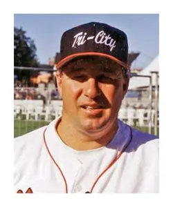 A baseball player wearing a hat and smiling.