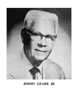 A black and white photo of an older man wearing glasses.