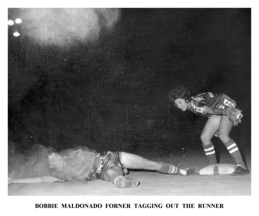 A baseball player laying on the ground after being tagged out.