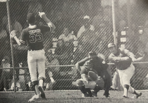 A baseball player is swinging at the ball.