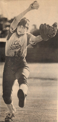 A woman in a baseball uniform throwing a ball.