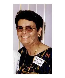 A woman with short hair and glasses wearing sunglasses.