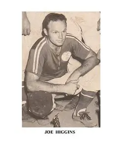 A black and white photo of a man holding a baseball bat.