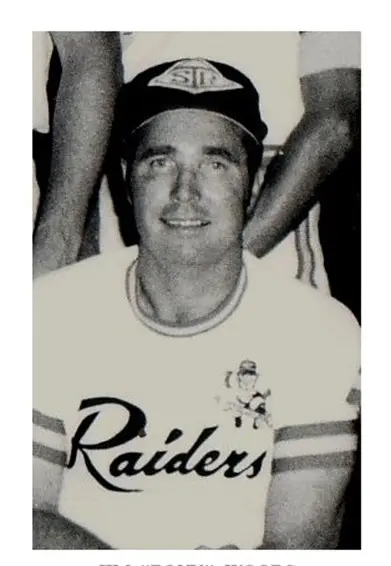 A black and white photo of a man in a raiders shirt.