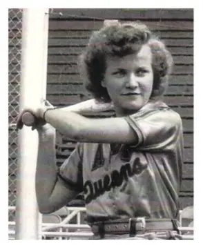 A young woman in a baseball uniform holding a bat.